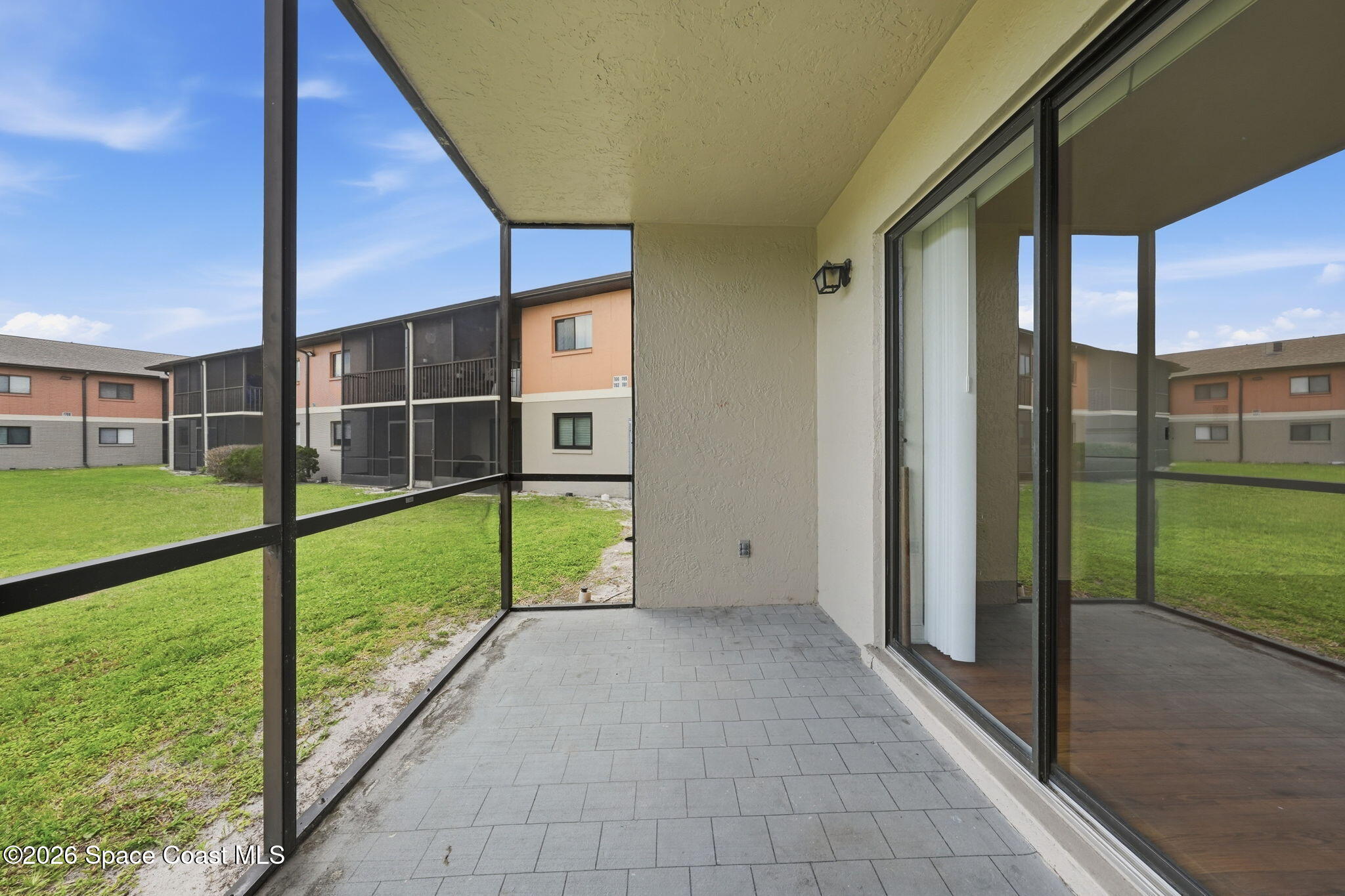 1702 University Lane, Unit 804 Cocoa, FL 32922 - Photo 21 of 25 a view of an empty room with floor to ceiling windows with yard