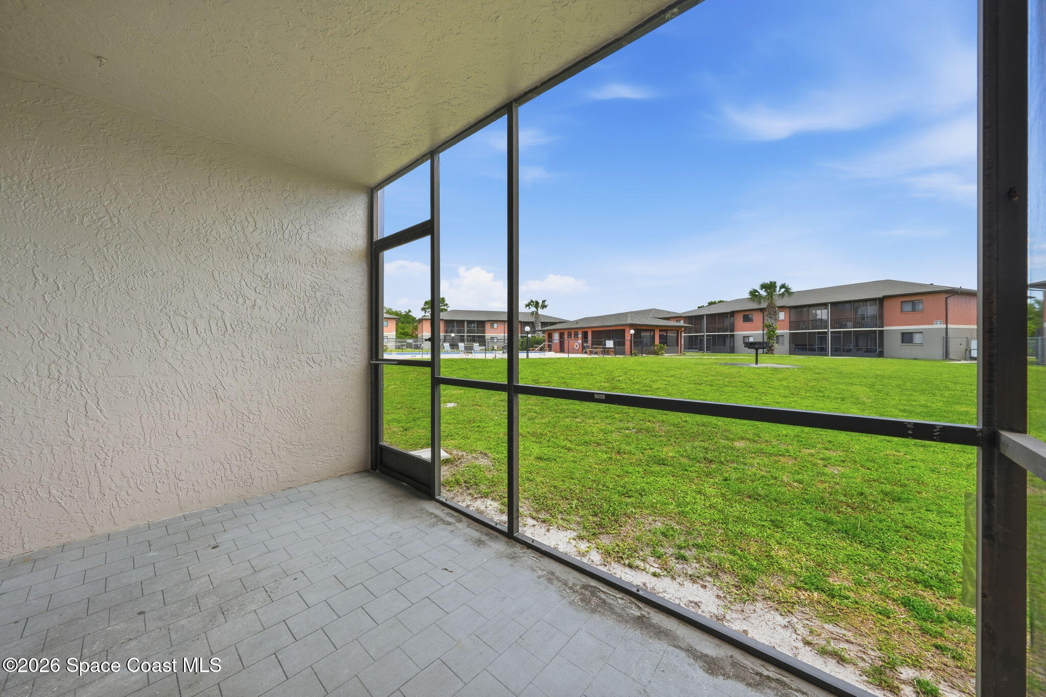 1702 University Lane, Unit 804 Cocoa, FL 32922 - Photo 22 of 25 a view of a living room and floor to ceiling window
