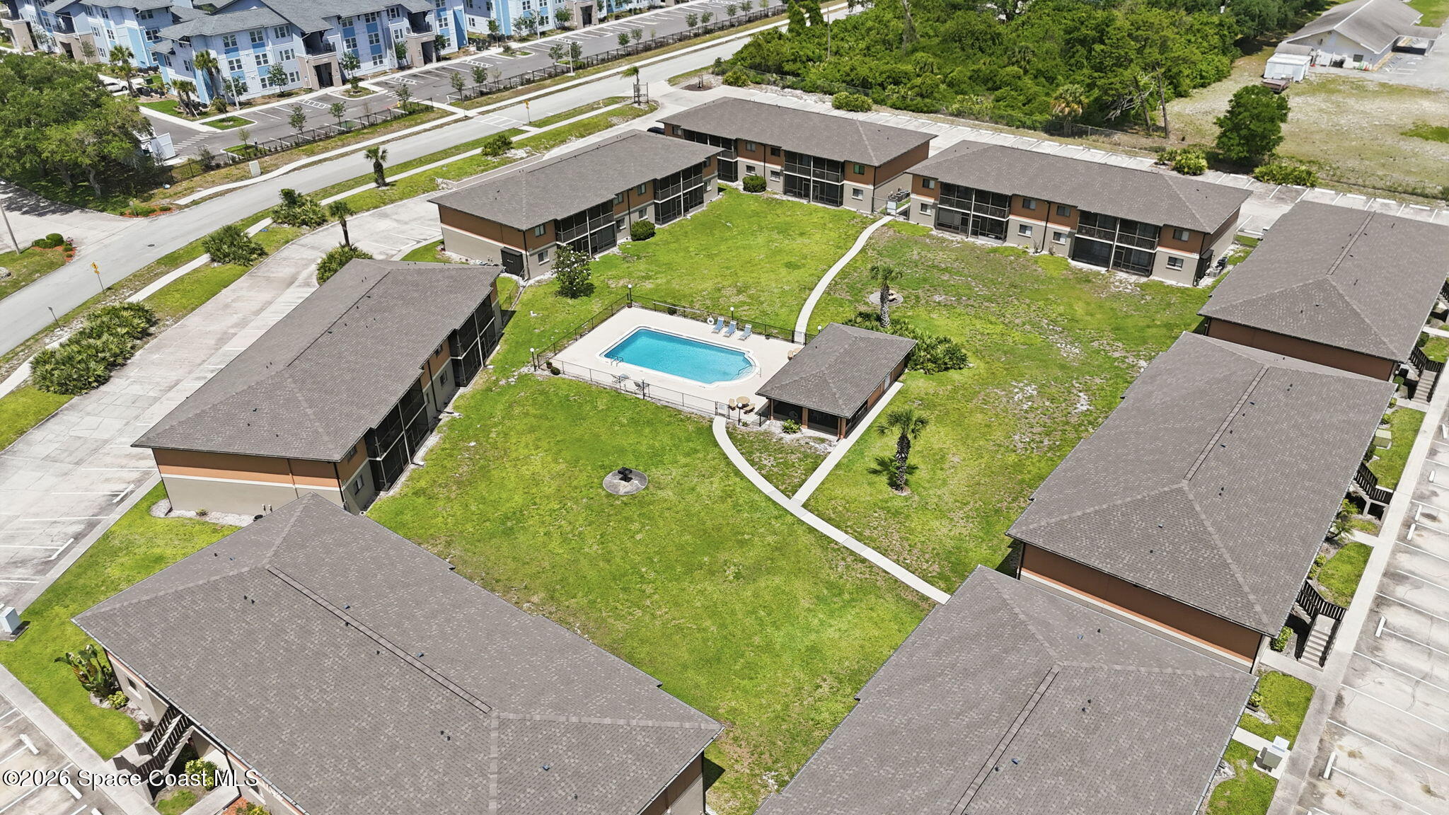 1702 University Lane, Unit 804 Cocoa, FL 32922 - Photo 25 of 25 an aerial view of a house with a garden and swimming pool