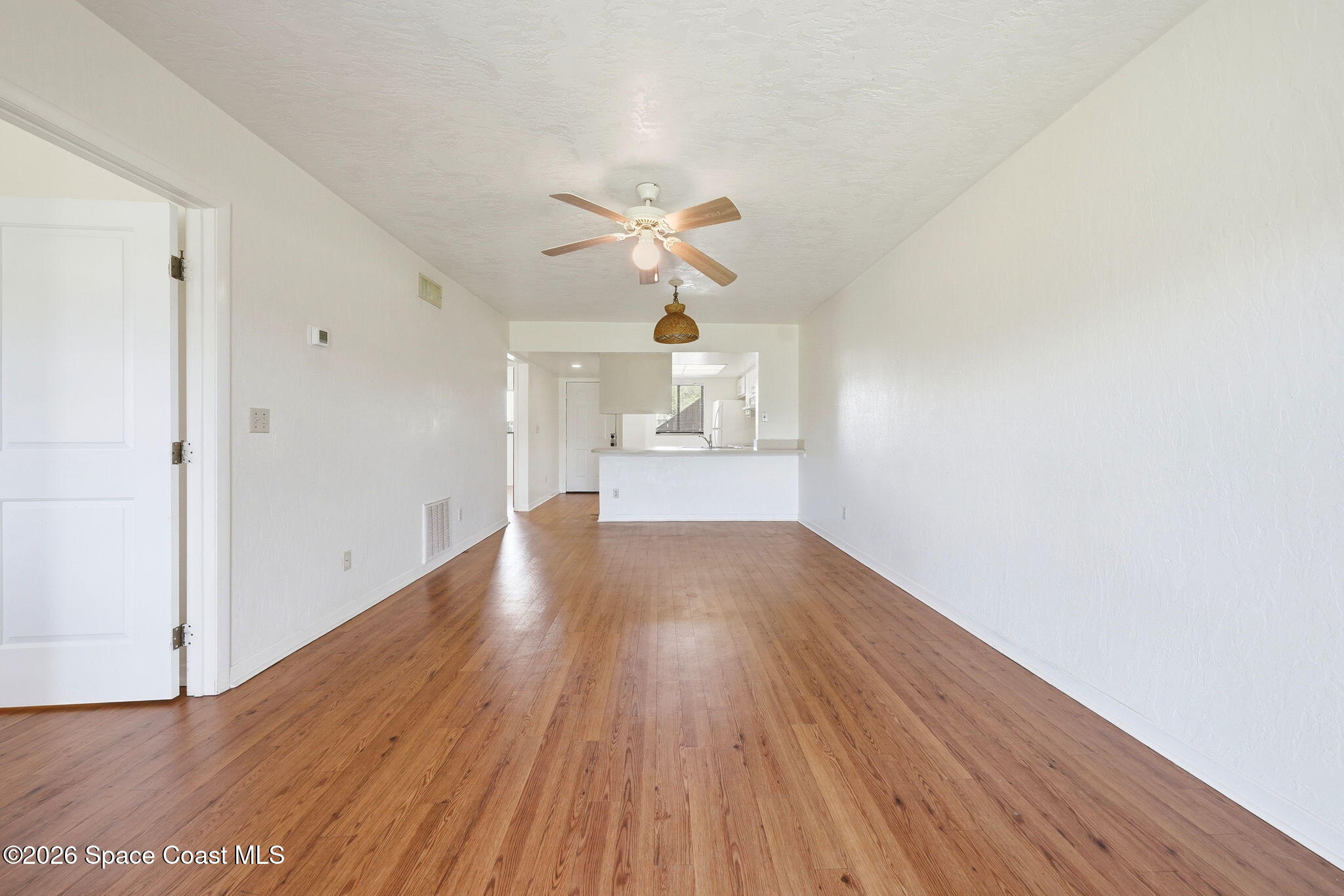1702 University Lane, Unit 804 Cocoa, FL 32922 - Photo 9 of 25 a view of empty room with wooden floor