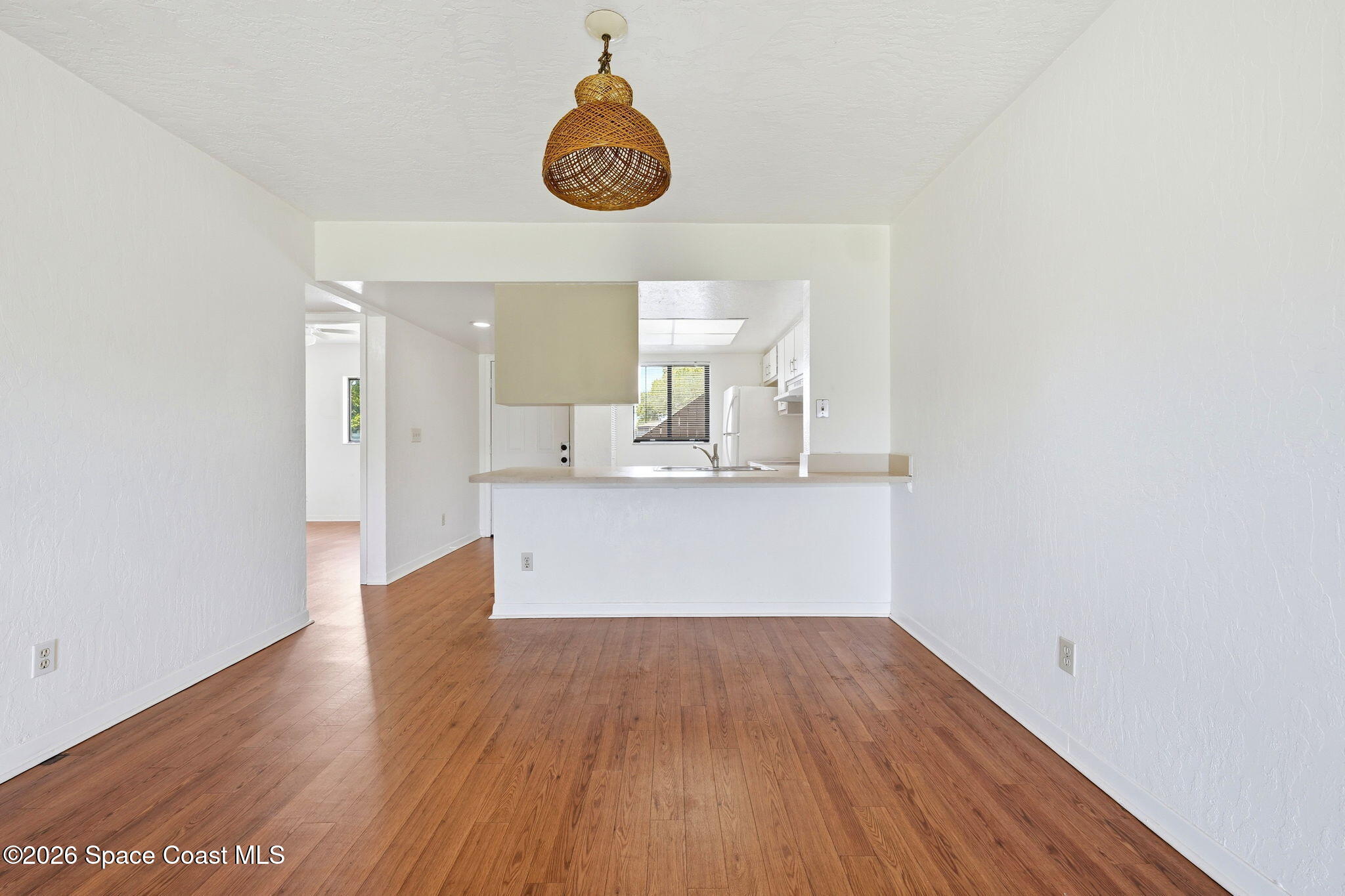 1702 University Lane, Unit 804 Cocoa, FL 32922 - Photo 10 of 25 an empty room with wooden floor and windows