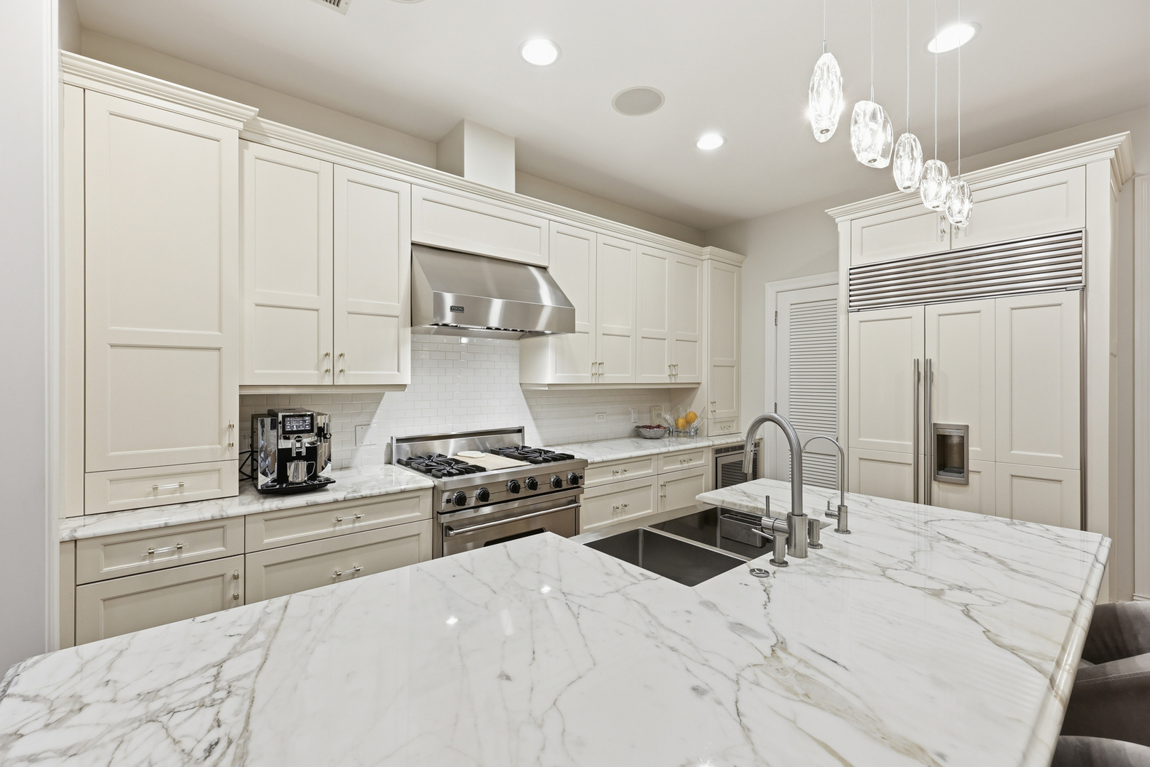 22 East Division Street, Unit 1 Chicago, IL 60610 - Photo 42 of 60 a kitchen with stainless steel appliances kitchen island granite countertop a stove a sink and white cabinets