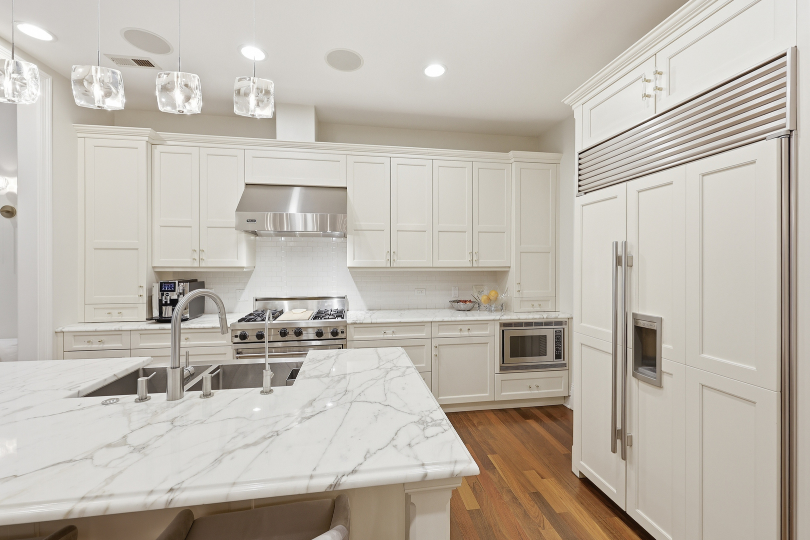 22 East Division Street, Unit 1 Chicago, IL 60610 - Photo 44 of 60 a kitchen with kitchen island a counter top space a sink stainless steel appliances and cabinets
