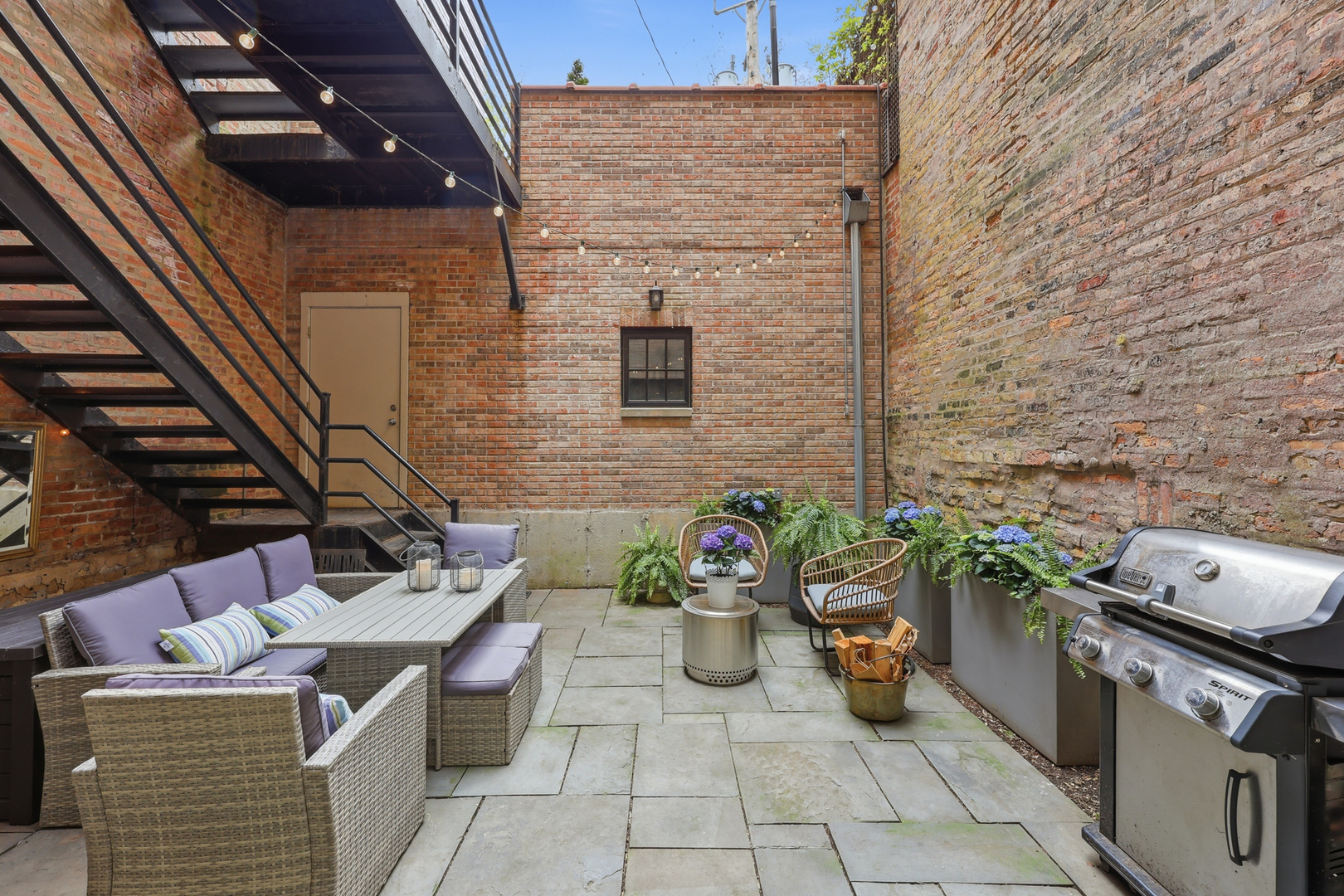 22 East Division Street, Unit 1 Chicago, IL 60610 - Photo 46 of 60 a view of a patio with table and chairs and potted plants