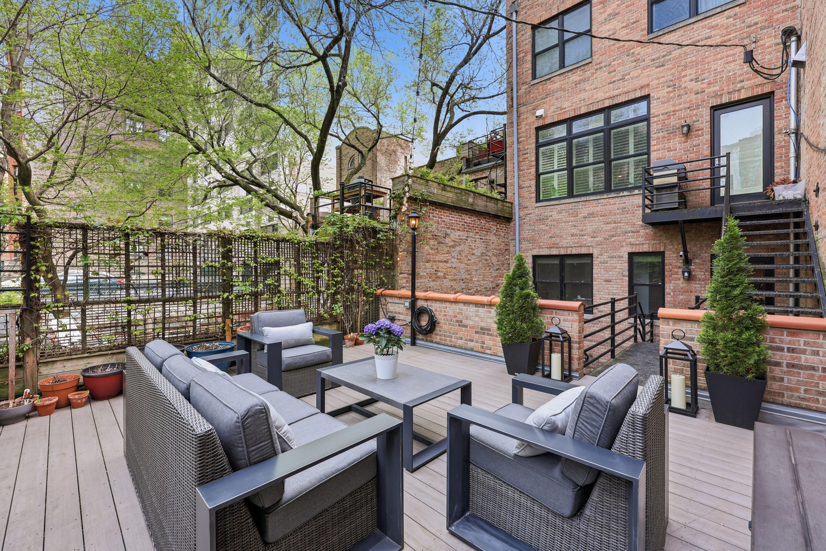 22 East Division Street, Unit 1 Chicago, IL 60610 - Photo 47 of 60 a view of a patio with couches table and chairs and potted plants