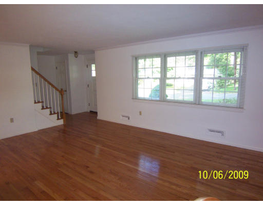 79 Hadley Street Springfield, MA 01118 - Photo 6 of 19 an empty room with wooden floor and windows