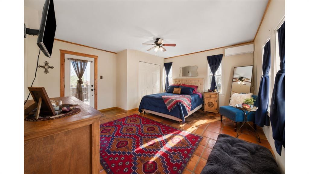 117 Reading Avenue North Center Point, TX 78010 - Photo 14 of 20 Spacious room featuring tile flooring, a ceiling fan, and multiple windows