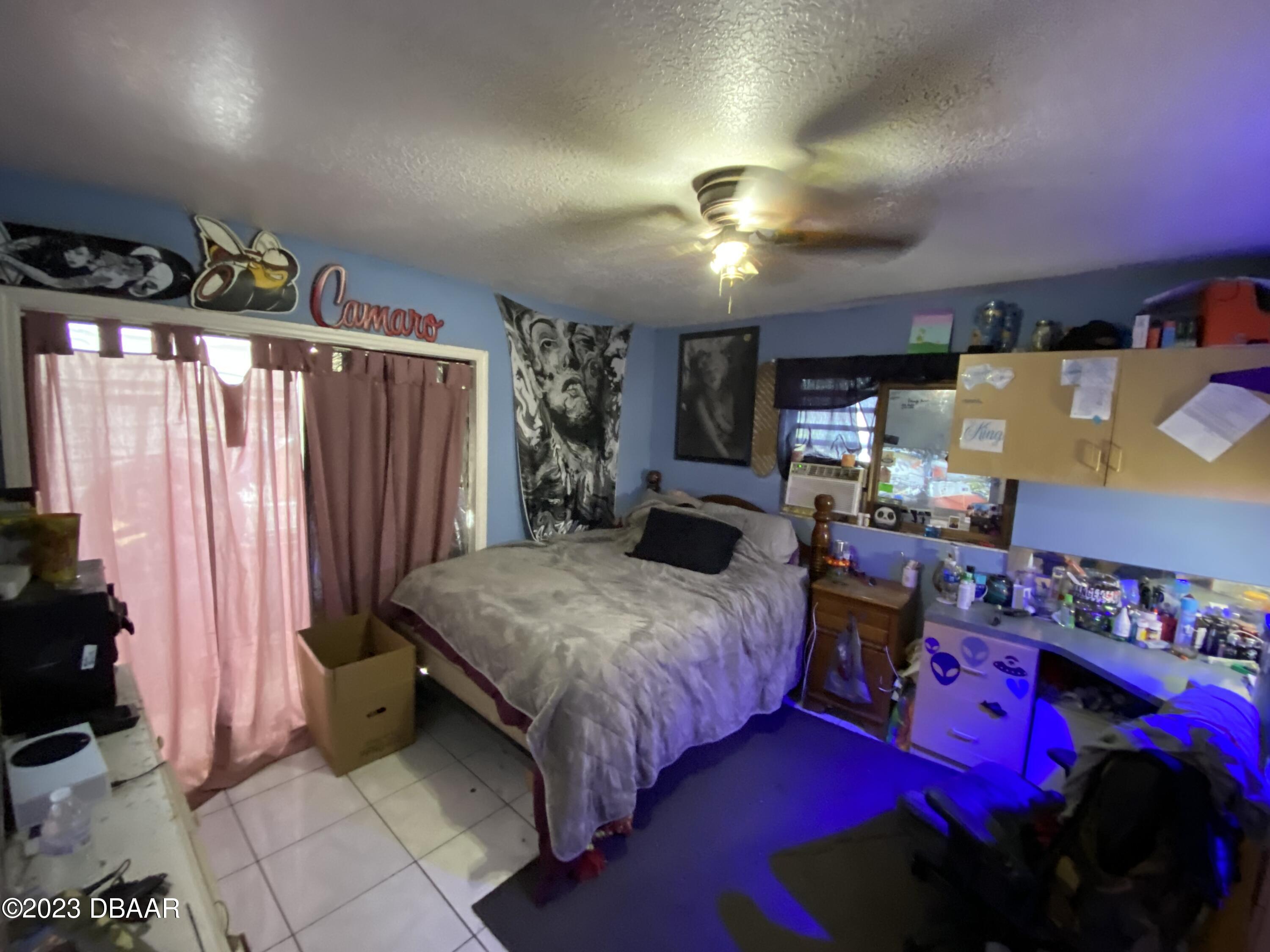 3315 Juniper Drive Edgewater, FL 32141 - Photo 16 of 20 a bedroom with a bed a mirror and dresser