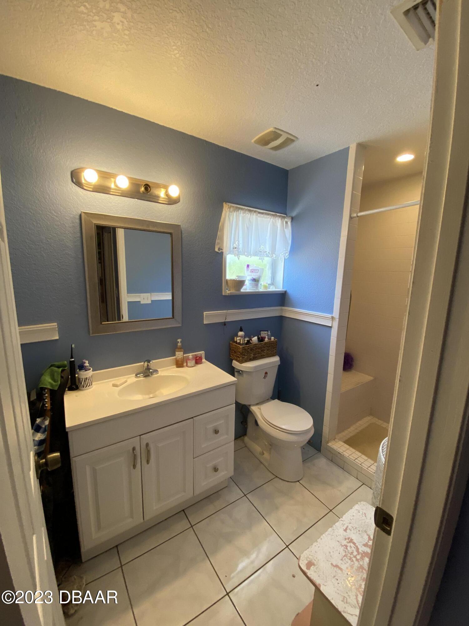3315 Juniper Drive Edgewater, FL 32141 - Photo 18 of 20 a bathroom with a toilet sink and mirror
