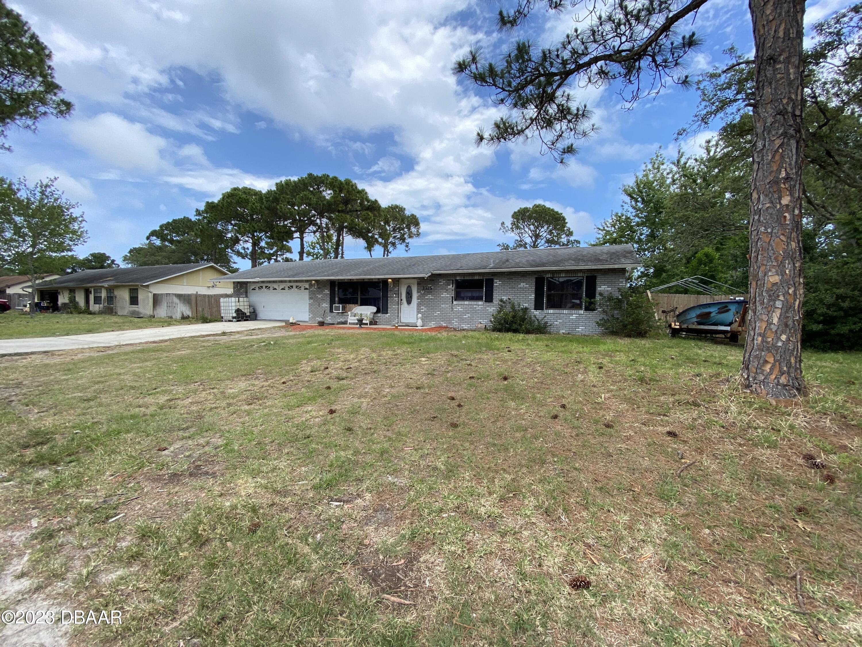 3315 Juniper Drive Edgewater, FL 32141 - Photo 4 of 20 a view of a house with a garden and a tree