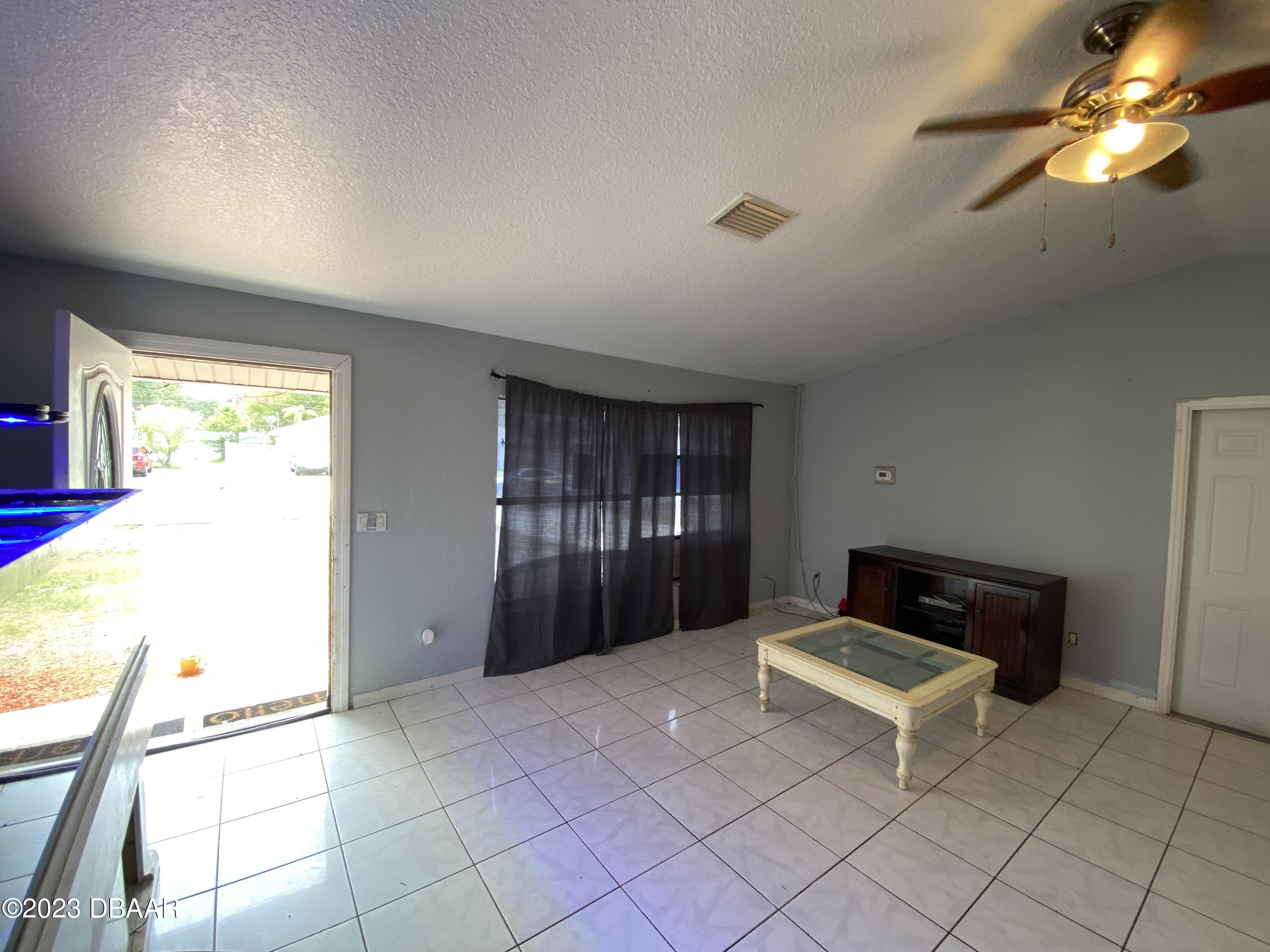 3315 Juniper Drive Edgewater, FL 32141 - Photo 5 of 20 a living room with a couch and a chandelier