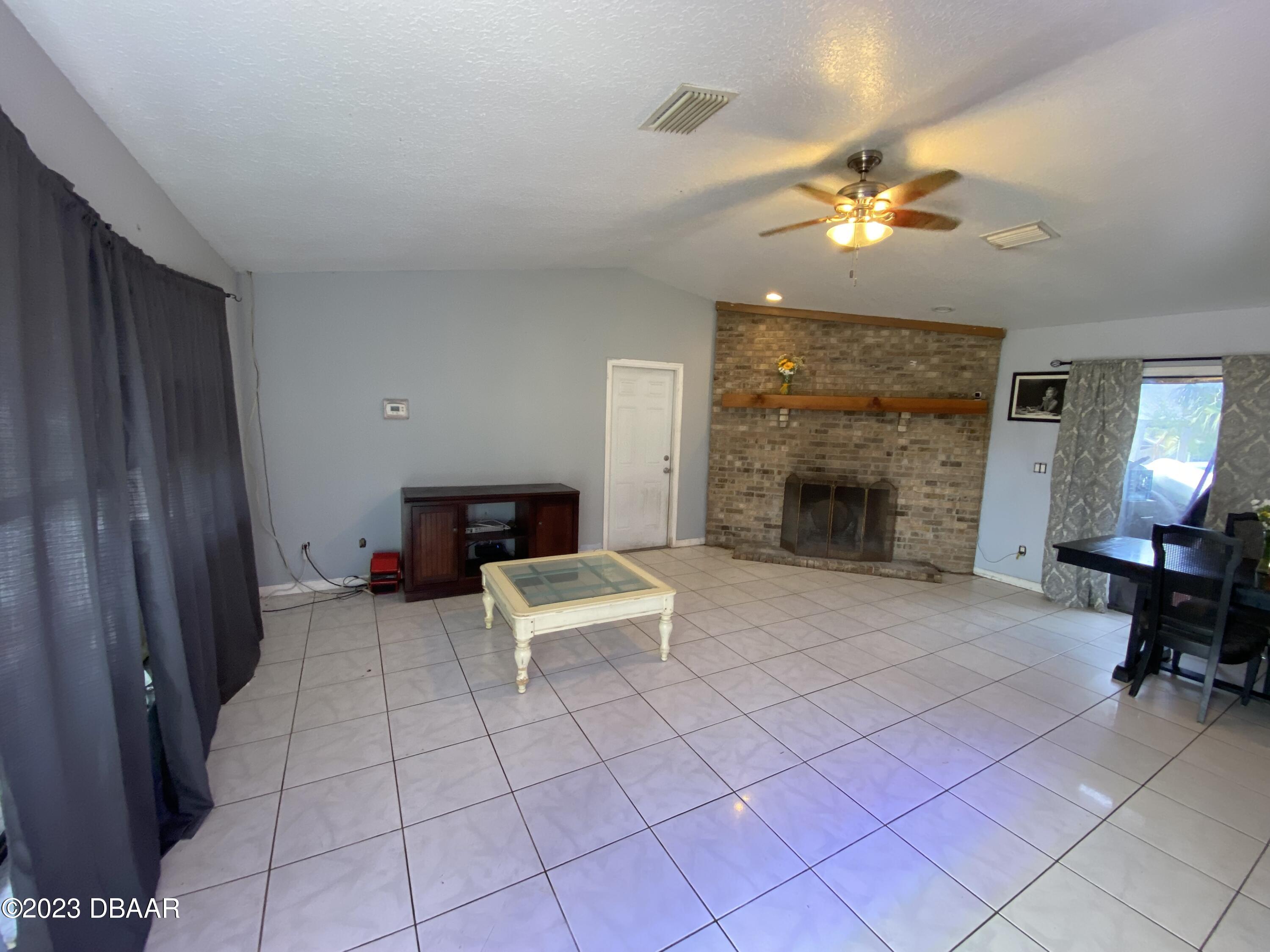 3315 Juniper Drive Edgewater, FL 32141 - Photo 6 of 20 a living room with furniture and a fireplace
