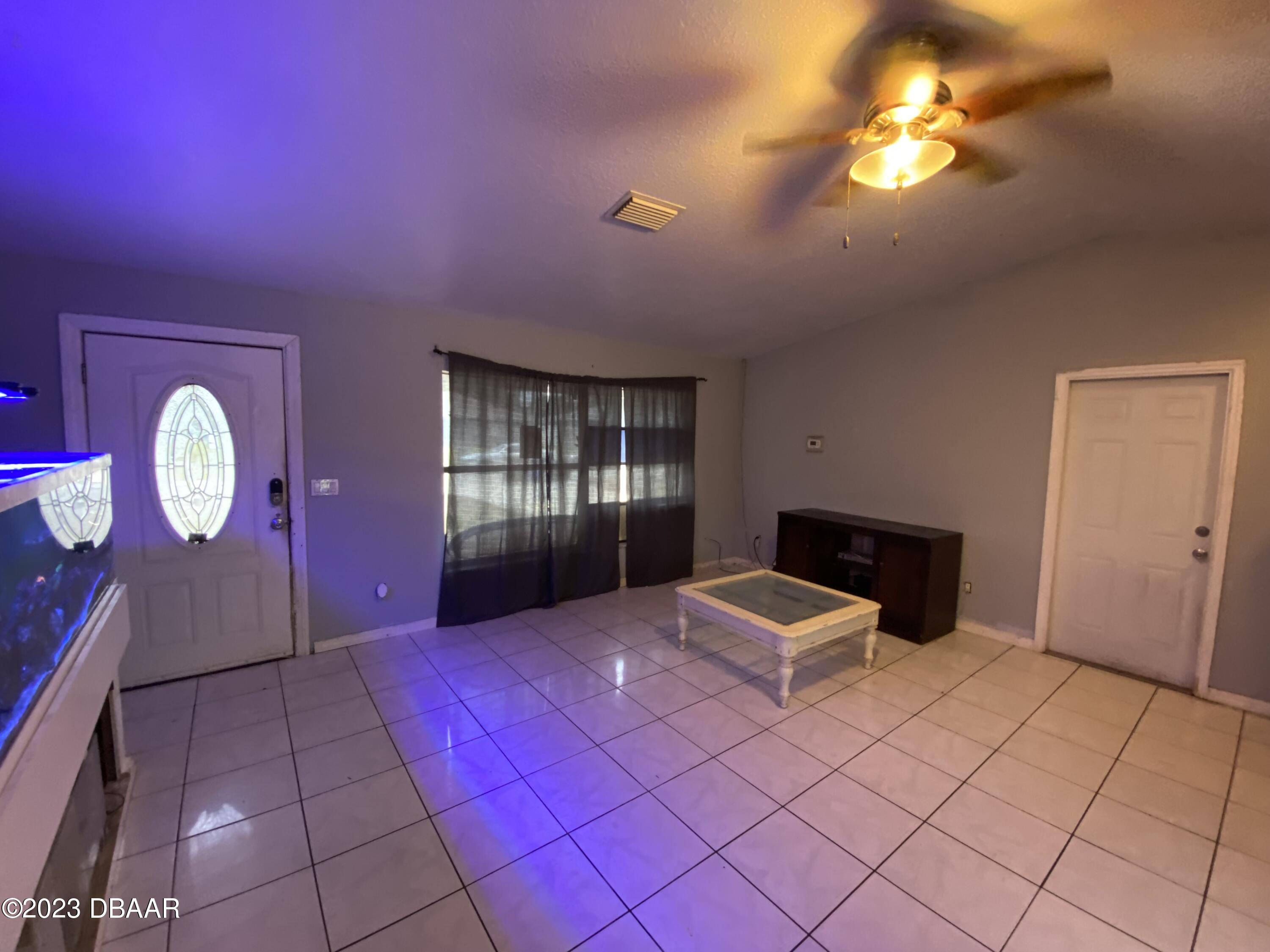 3315 Juniper Drive Edgewater, FL 32141 - Photo 7 of 20 a bedroom with a bed and a chandelier