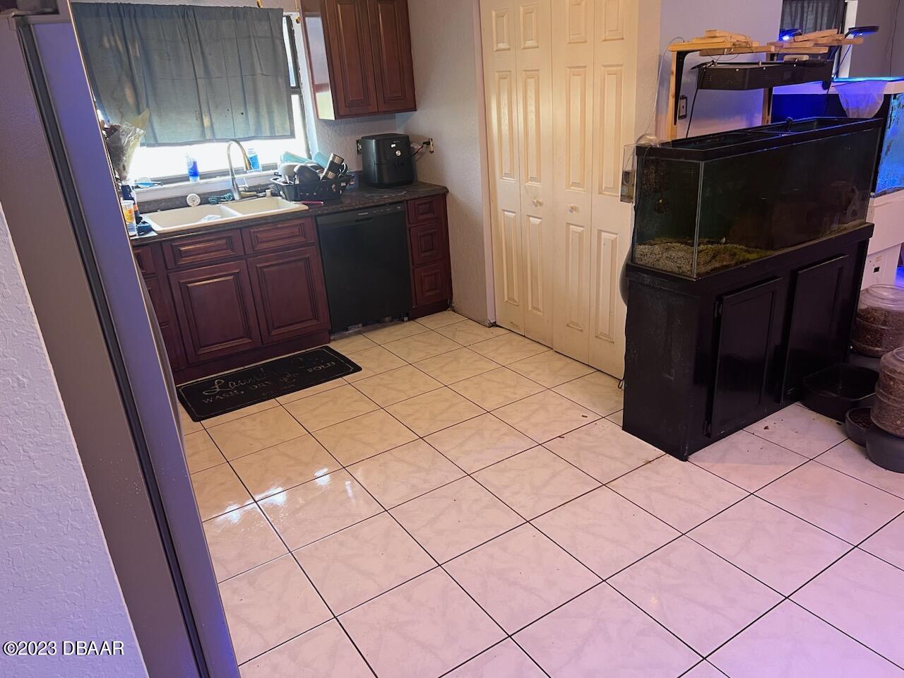3315 Juniper Drive Edgewater, FL 32141 - Photo 9 of 20 a kitchen with a refrigerator and cabinets