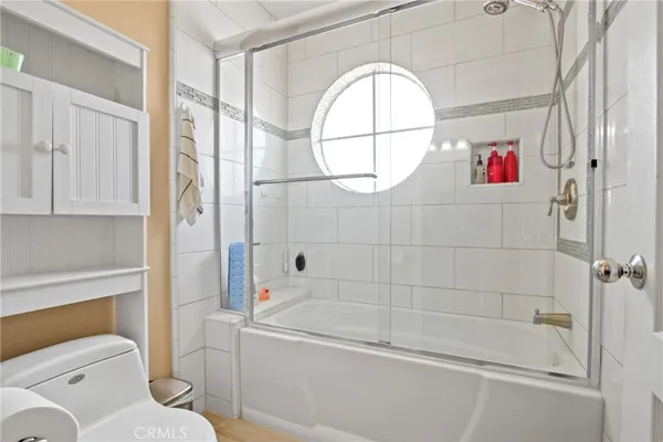 a bathroom with a toilet and a shower