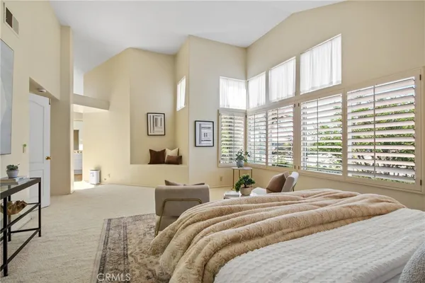 a bedroom with a large bed and a large window