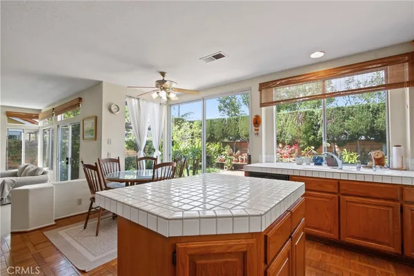 a kitchen with granite countertop sink stove and dining table