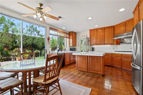 a kitchen with a dining table chairs and granite counter top