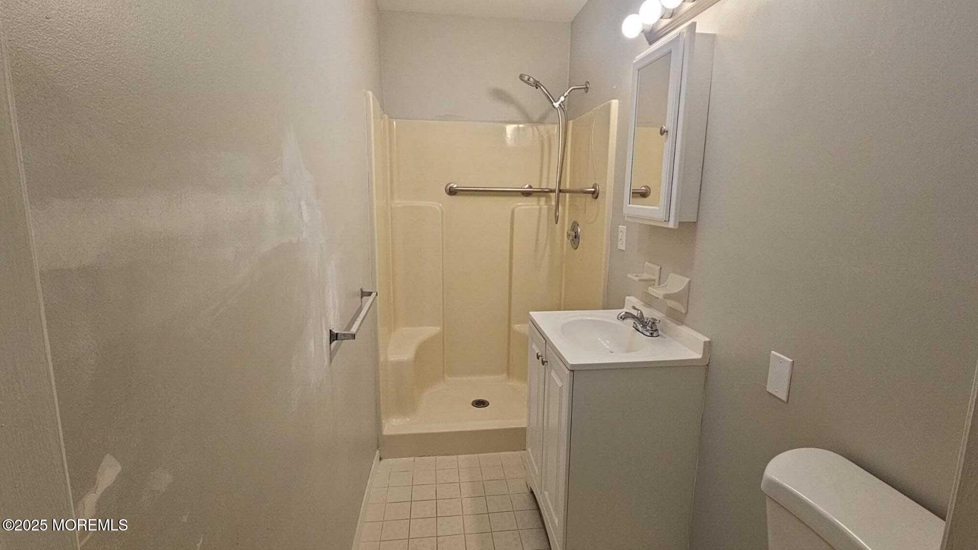 1700 Highway 37, Unit 10206 Toms River, NJ 08757 - Photo 8 of 9 a bathroom with a sink a toilet and shower