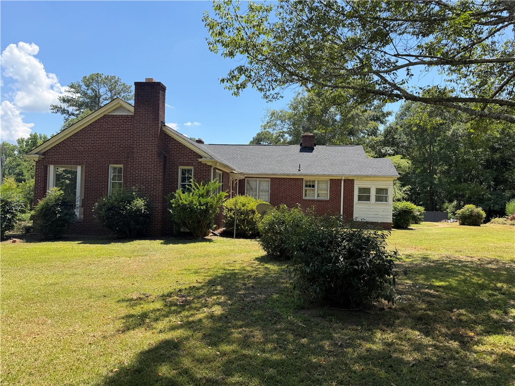 715 Concord Road Anderson, SC 29621 - Photo 4 of 24 A classic brick exterior offers enduring appeal with a welcoming green lawn.