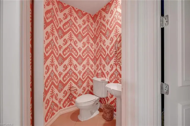 a bathroom with a toilet and a shower curtain