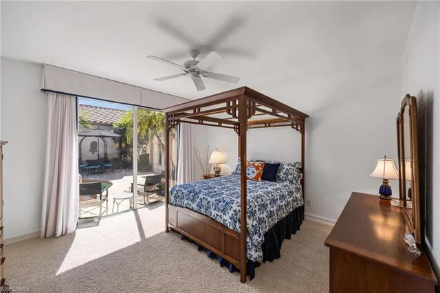 a bedroom with a bed and a mirror