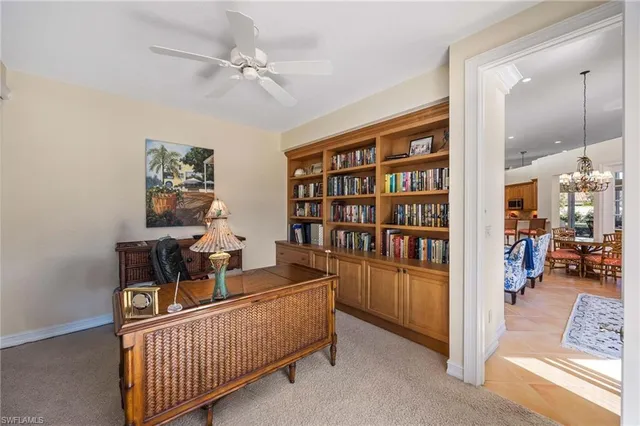 a living room with furniture and a book shelf