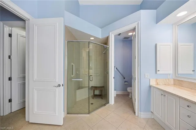 a bathroom with a granite countertop shower mirror and a sink