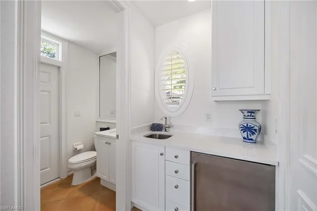 a bathroom with a sink a toilet and a window