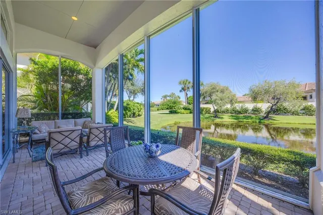 a view of a patio with couches chairs dining table and chairs next to a yard