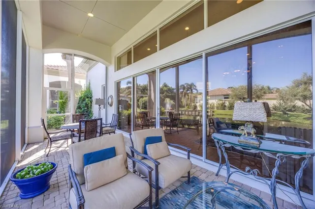 a living room with furniture city view and large windows