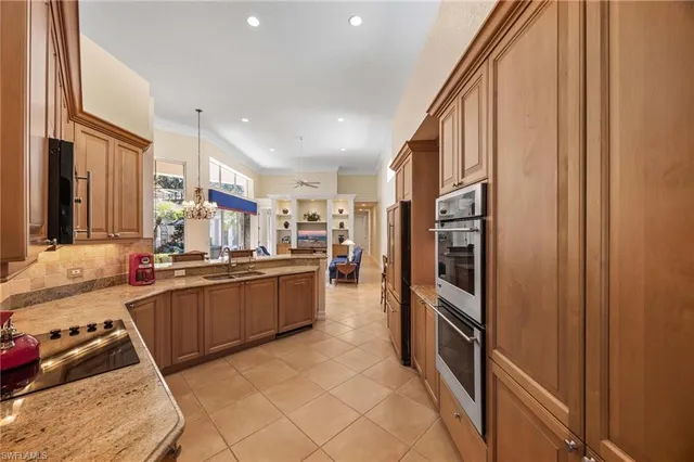 a kitchen with stainless steel appliances granite countertop a refrigerator and a stove