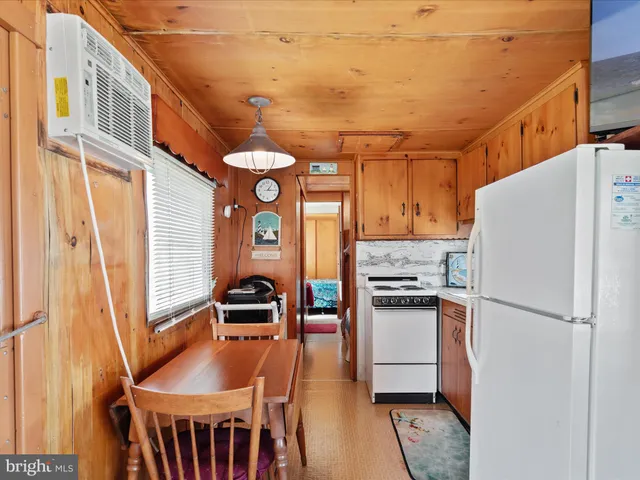 a kitchen with stainless steel appliances granite countertop a refrigerator a stove and a refrigerator with wooden floor