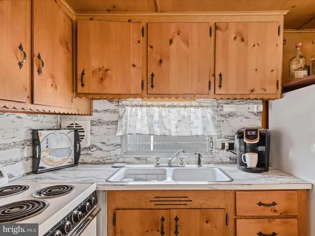 a kitchen with a stove and a sink