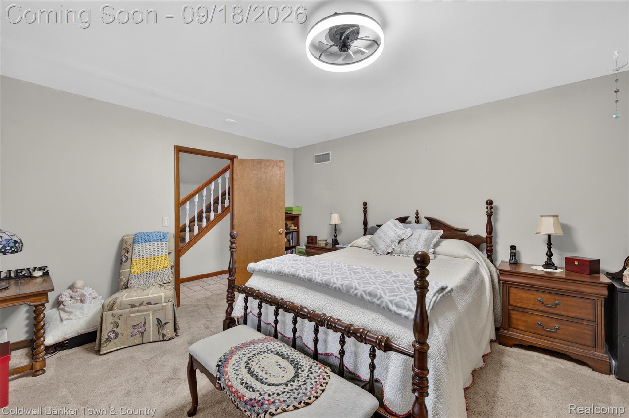 4442 McGunn Road Howell, MI 48843 - Photo 24 of 63 Ceiling-mounted light fixture, light-toned wall paint, neutral carpet flooring, wood door frame, and wood newel post with balusters