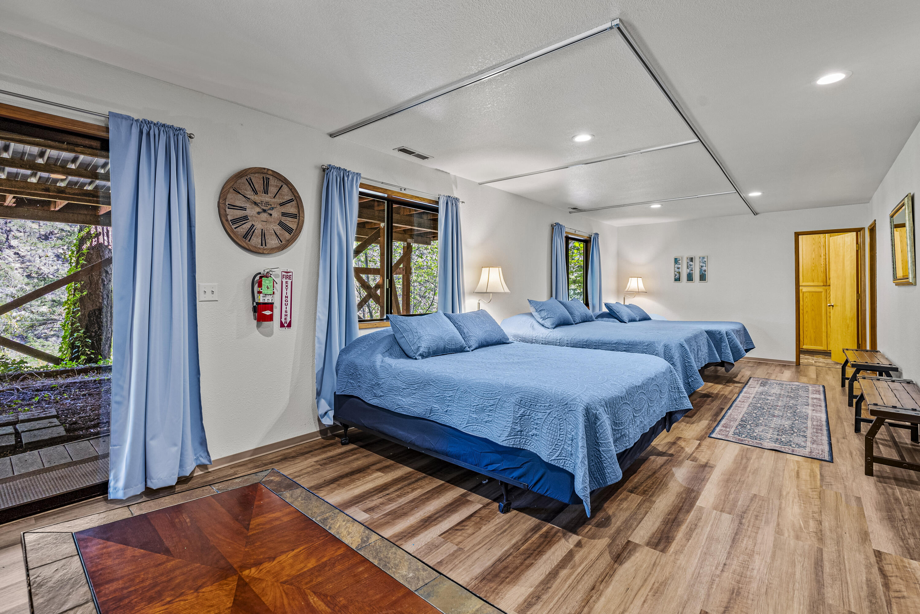 11744 Galice Road Merlin, OR 97532 - Photo 42 of 74 a spacious bedroom with a bed and a dresser with wooden floor