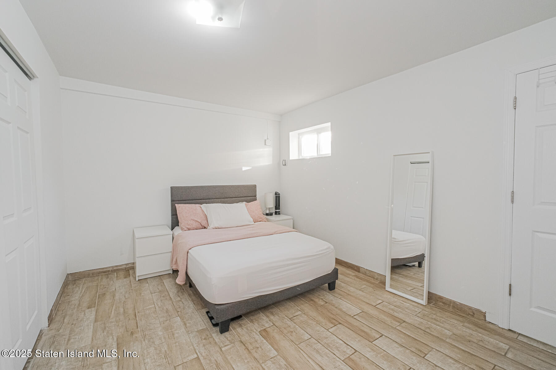 43 Maple Terrace Staten Island, NY 10306 - Photo 11 of 32 a bedroom with a bed and wooden floor