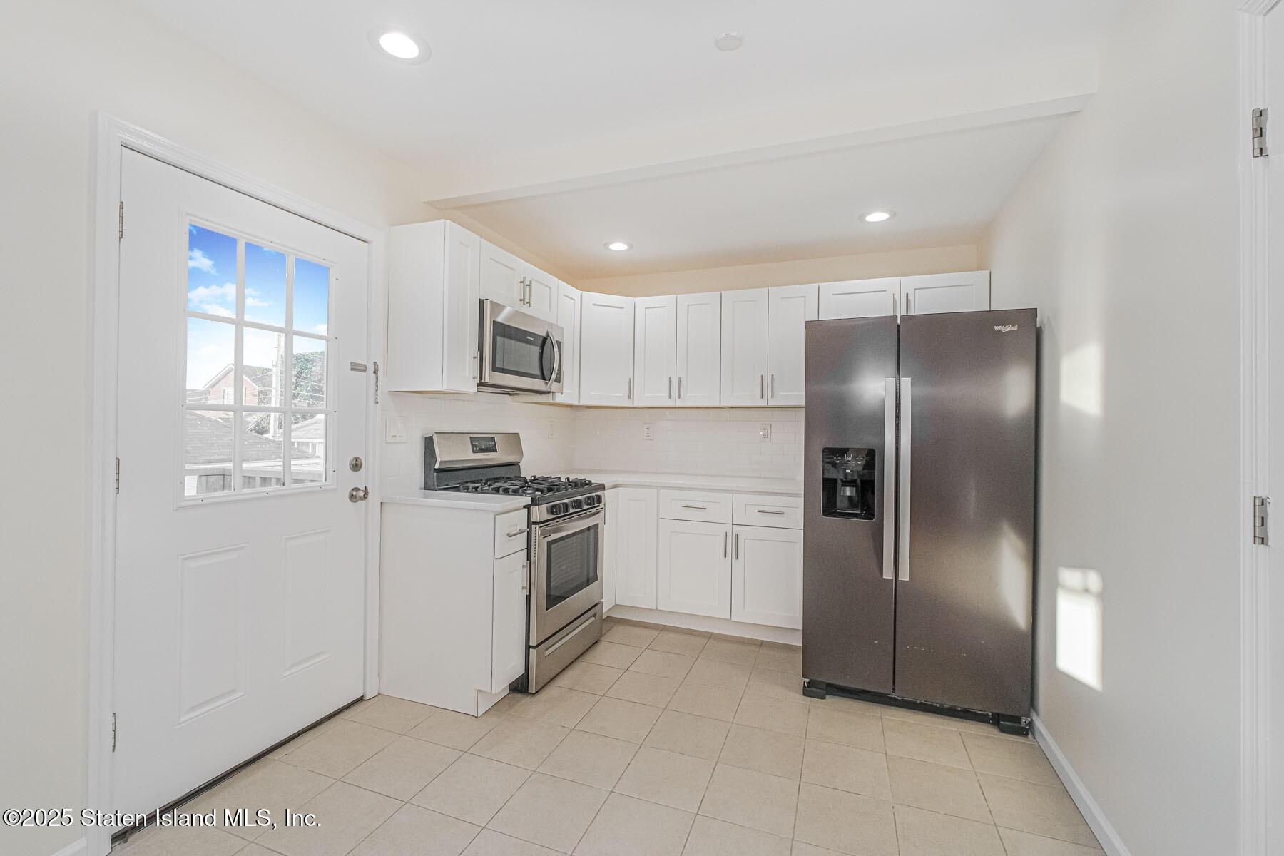 43 Maple Terrace Staten Island, NY 10306 - Photo 16 of 32 a kitchen with stainless steel appliances granite countertop a refrigerator a sink a stove top oven and a dishwasher
