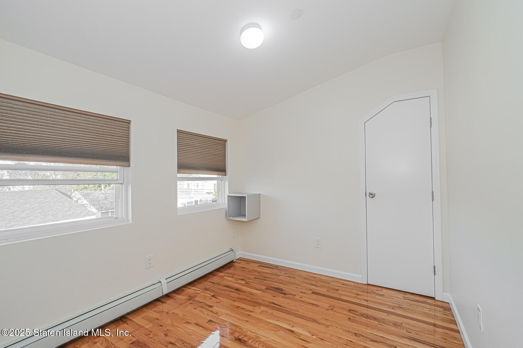 43 Maple Terrace Staten Island, NY 10306 - Photo 24 of 32 a view of empty room with wooden floor and fan