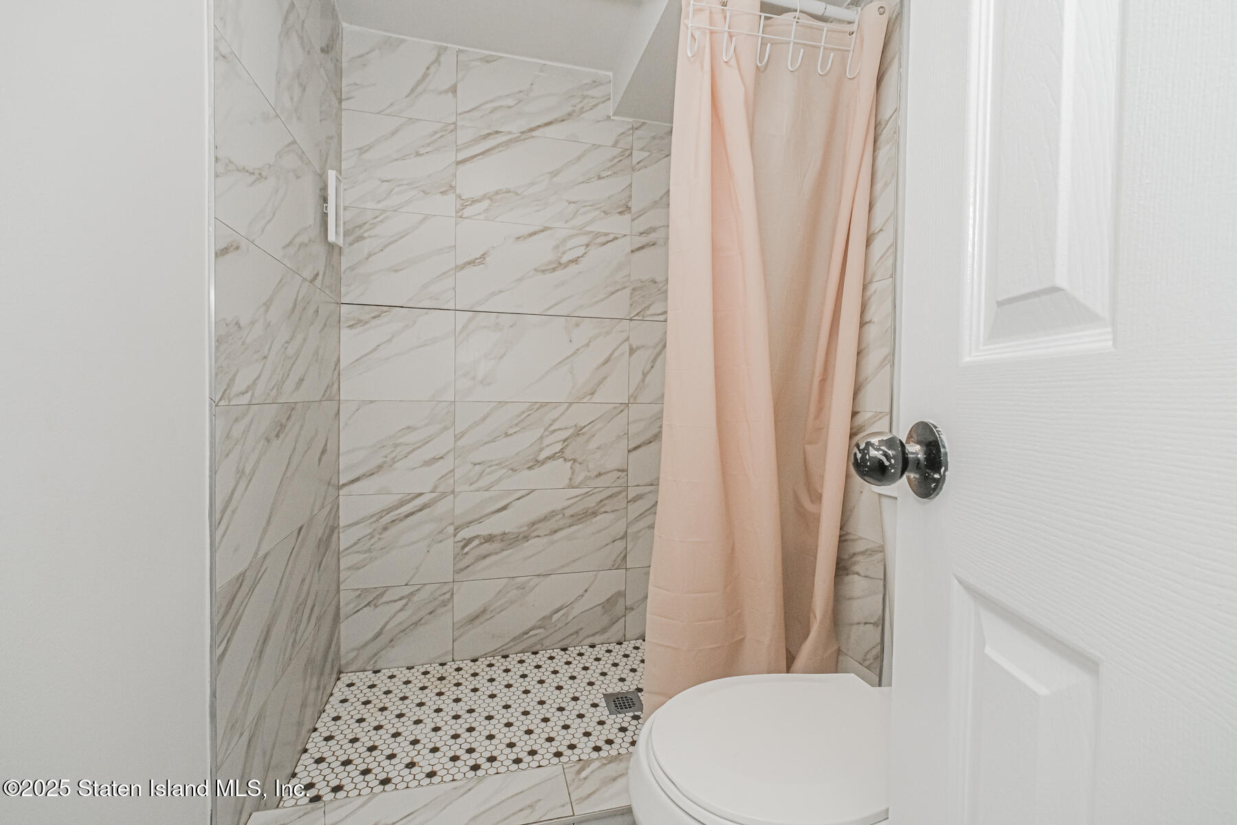 43 Maple Terrace Staten Island, NY 10306 - Photo 32 of 32 a bathroom with a toilet and a shower curtain