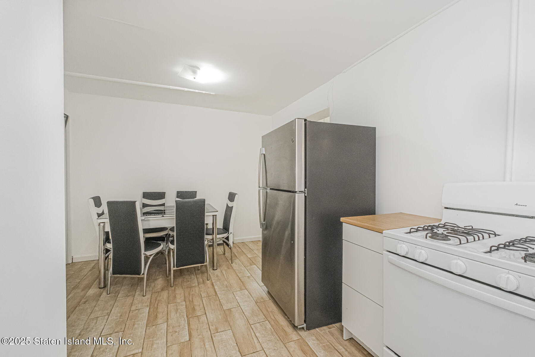 43 Maple Terrace Staten Island, NY 10306 - Photo 8 of 32 a kitchen with a refrigerator and table