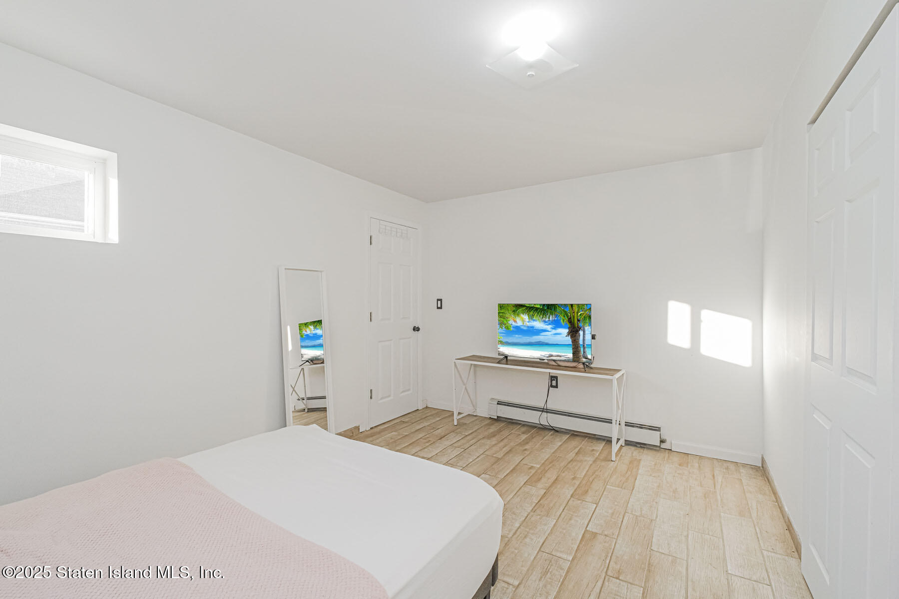 43 Maple Terrace Staten Island, NY 10306 - Photo 10 of 32 a bedroom with a bed and a table