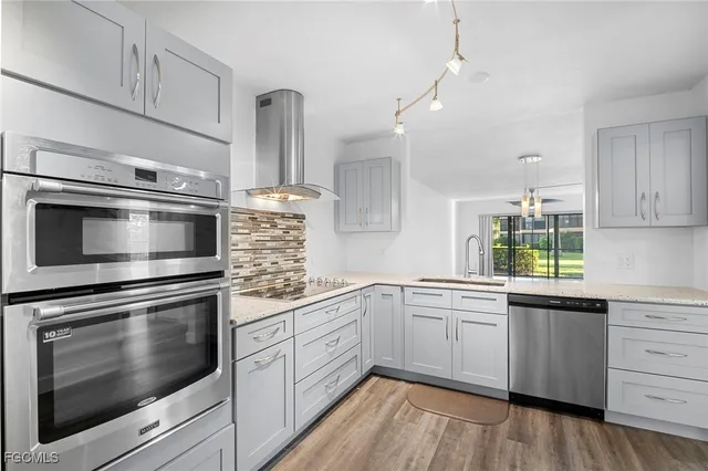 a kitchen with a sink stove and microwave