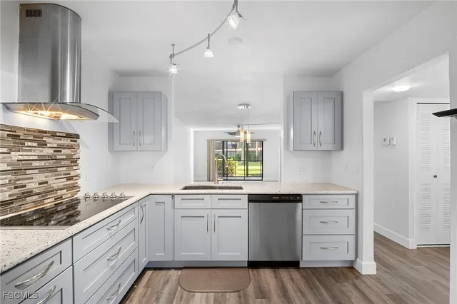 a kitchen with granite countertop white cabinets and white appliances