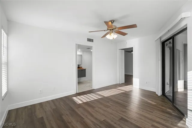 a view of room with wooden floor and ceiling fan