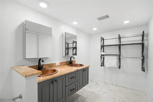 a bathroom with double sink and a mirror