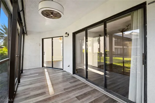 a view of a room with wooden floor and windows