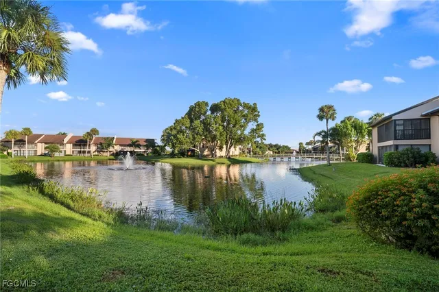 a view of a lake with houses in the back