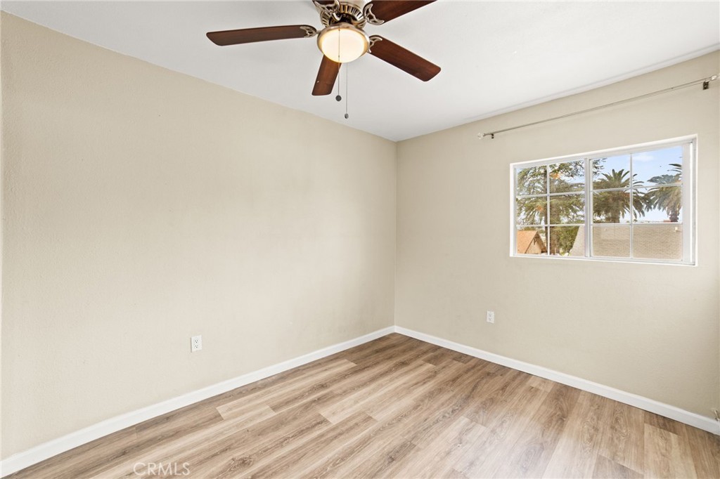 3717 Roosevelt Street Riverside, CA 92503 - Photo 13 of 23 a view of an empty room with window and wooden floor