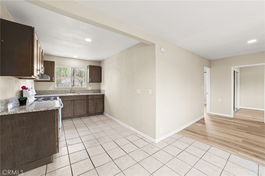 3717 Roosevelt Street Riverside, CA 92503 - Photo 16 of 23 a view of a kitchen with kitchen island granite countertop a sink and a stove top oven